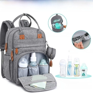 Detail view of the insulated foil pockets for 9-inch baby bottles in the gray diaper bag