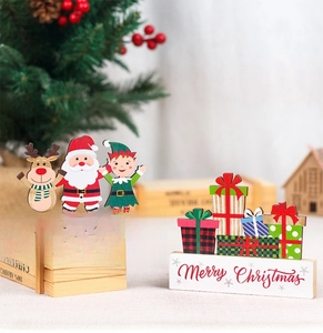 Detailed view of Christmas wooden table ornaments with Merry Christmas lettering on base