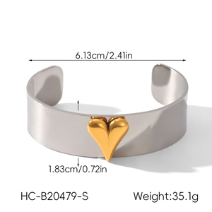 Detail view of two-tone stainless steel cuff bracelet with golden heart and size markings