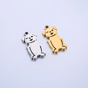 Macro detail of polished stainless steel dog charms in silver and gold for DIY jewelry