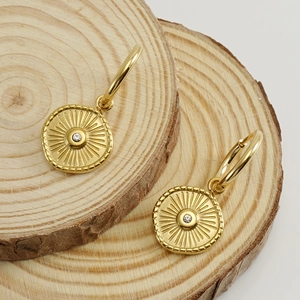 18K gold plated stainless steel hoop earrings with crystal sunburst charms on wood