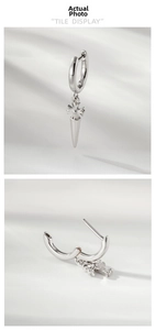 Detail view of silver cross pendant earring with polished finish and tile display