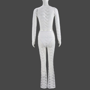Detail view of the back of a white lace two-piece set with crop top and flared pants