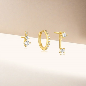Macro shot of S925 sterling silver gold plated earring set with white zircon stones