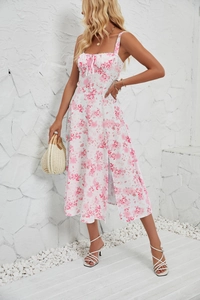 Detailed view of the side slit and pink floral print on a white summer sleeveless dress