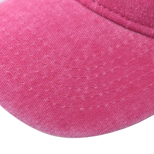 Close-up of pink washed cotton baseball cap brim with precise five-row stitching detail