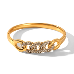Detailed macro view of gold-plated cuff bracelet featuring a crystal-pave chain design
