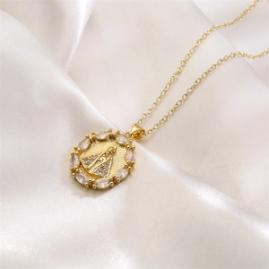 Close-up of a gold-plated Our Lady of Aparecida pendant with marquise-cut zircon stones