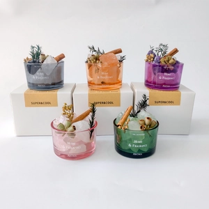 Detailed set of colorful glass oil diffusers with natural crystals and dried flowers