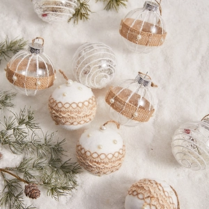 Chic clear Christmas tree ornaments with burlap and pearl details on snowy pine background