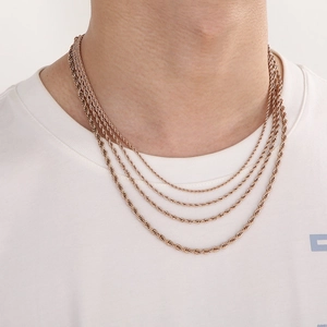 Elegant rose gold twisted rope chain necklace for layered style on female model neck