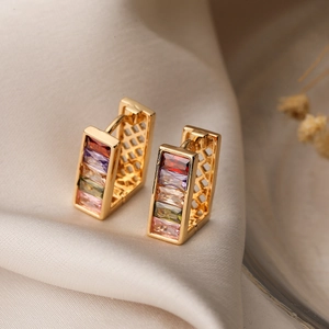Luxurious gold plated geometric hoop earrings with colorful zircon stones on silk fabric