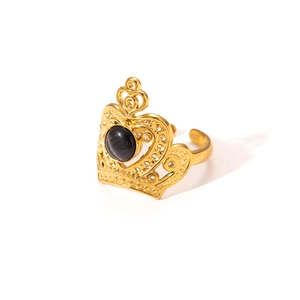 Detail of crown shaped gold titanium steel ring with black gemstone and open band design
