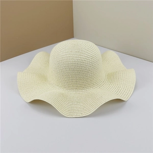 Detailed close-up of high-quality woven texture on a cream wavy brim sun hat