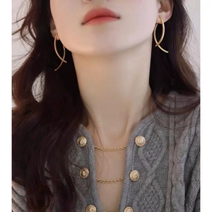 Elegant gold long spiral earrings and matching double-layered necklace set on model