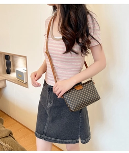 Close-up of retro geometric pattern small square crossbody bag with adjustable strap