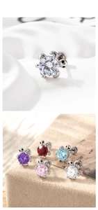 Macro view of turtle ear studs with colorful round cut zircon stones and screw backings
