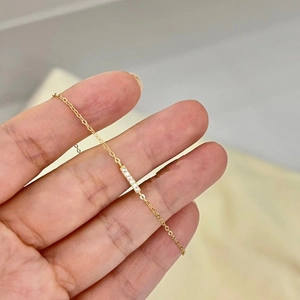 Minimalist S925 sterling silver bar bracelet plated in 14k gold with five small diamonds