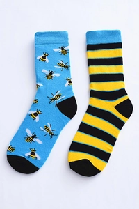 Detail of mismatched cotton crew socks with bee pattern and yellow black stripes