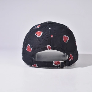 Detail view of the adjustable silver buckle and heart pattern on a distressed baseball cap