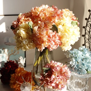 Artistic close-up of colorful vintage hydrangea bouquets in a glass vase for home decor