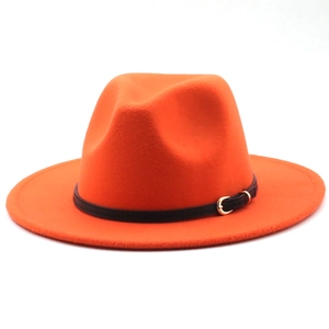 Close-up of bright orange wool fedora hat with black band and gold metal buckle