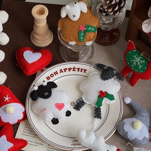 Close-up of handmade felt Christmas ornaments including sheep, gnomes and hearts
