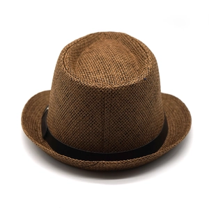 Close-up of a dark brown straw fedora with a black band showing fine woven texture