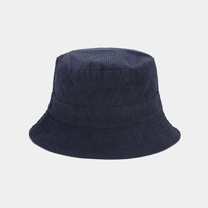 Close-up of high-quality navy blue corduroy fabric texture on a stylish bucket hat