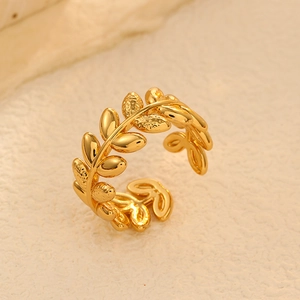 Close-up detail of golden olive leaf ring with micro-engraved frosted texture details