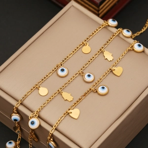 Layered gold stainless steel evil eye necklace with Hamsa hand and heart charms