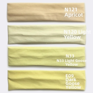 Detailed stack of multi-color cotton sports headbands in beige and yellow shades