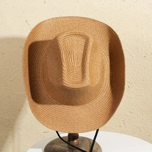 Handwoven straw cowboy hat in camel brown with wide brim and black windproof chin strap