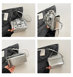 Detailed views of silver motorcycle jacket crossbody bag with floral rivets and zippers