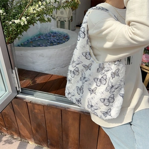 Detail of canvas tote bag with dark blue butterfly print and thick fabric texture