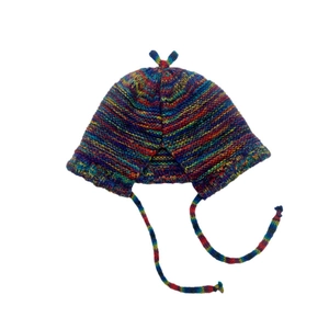 Detail of colorful rainbow striped knit beanie showing ear flaps and strap texture