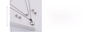 Macro detail of polished butterfly pendant and ball studs with size specifications