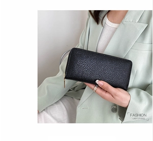 Close-up of black lychee grain PU leather long wallet with premium gold zipper detail