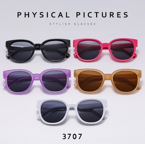 Flat lay array of round frame sunglasses in black, pink, purple, tea, and white colors