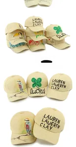 Detailed macro view of handcrafted straw baseball cap with artistic hand-painted bird motifs