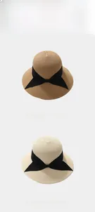 Detail of woven straw beach hat with wide black grosgrain ribbon and bow decoration