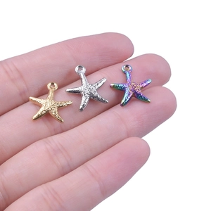 Starfish pendants in gold, silver and rainbow titanium steel shown on a hand palm
