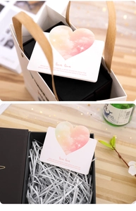 Detailed view of a 3D heart greeting card set in gift packaging with warm ambient lighting