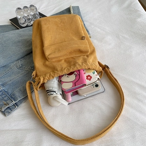 Ginger yellow corduroy shoulder bag showing spacious interior with daily essentials