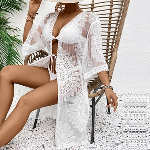 Close-up of white floral crochet lace beach cover-up with tie-up waist detail