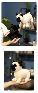 Close-up of black and white French bulldog plush toys in a cozy indoor setting