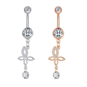 Detail of silver and rose gold belly rings with hollow floral design and zircon pendant