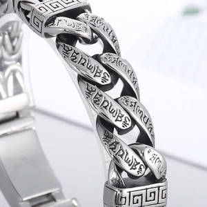 Macro shot of stainless steel Cuban chain bracelet with engraved Buddhist mantras and silver finish