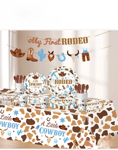 Detailed view of My First Rodeo party supplies including cowboy themed plates and banners