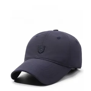 Detail of navy blue winter baseball cap with ear protection and shield logo embroidery